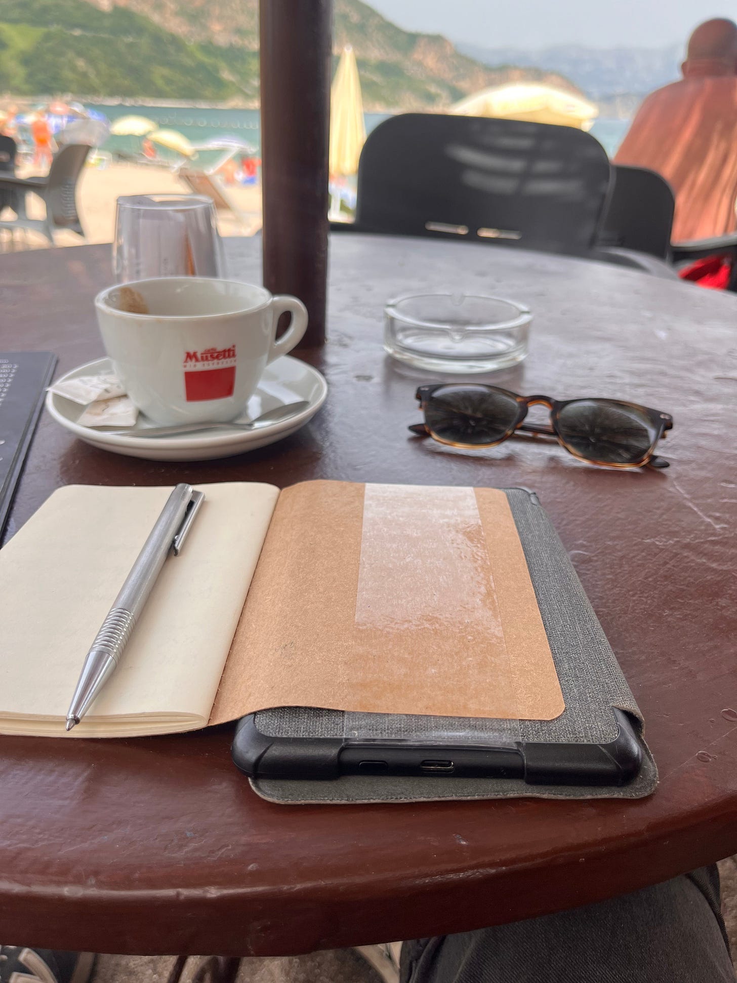 The final prototype of a DIY 2-in-1 notebook with strong tape for attachment, showcasing the integration of an e-reader and notebook for enhanced accessibility.