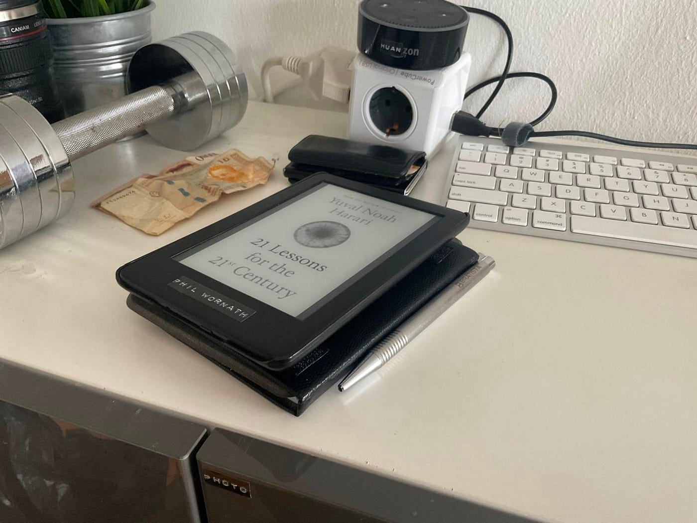 Prototype setup showing an e-reader attached to a journal with velcro tape for ergonomic testing.